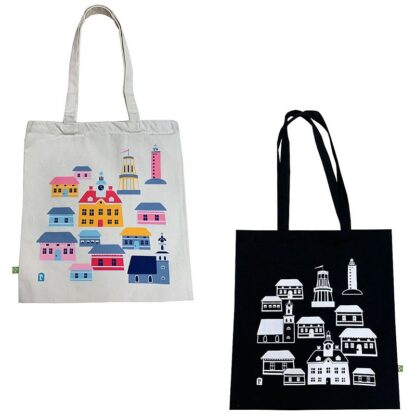 The picture shows two canvas bags. The white bag has Rauma's most famous buildings printed in color, and the black bag has the same print in white.